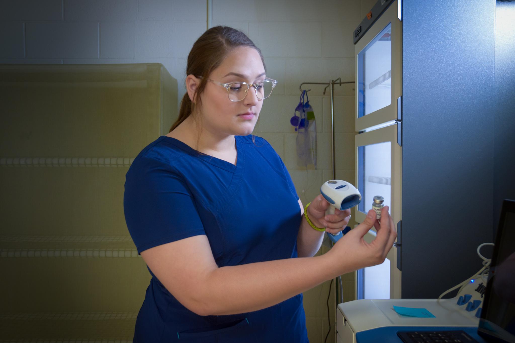 Nursing student scanning a bottle